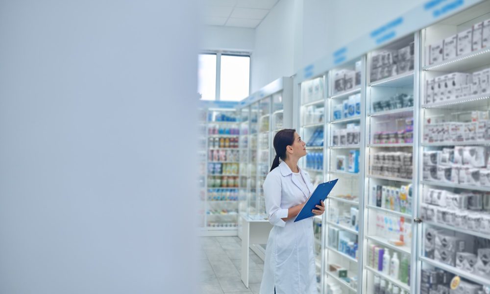 Drugstore. Pharmacist checking medicines in a drugstore